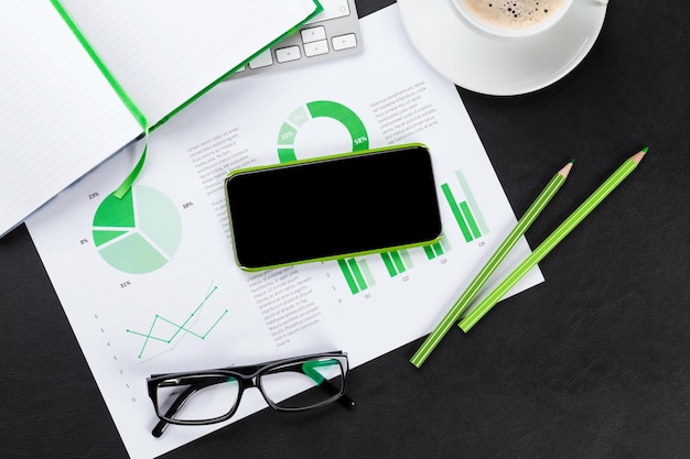 Office desk with phone charts and coffee