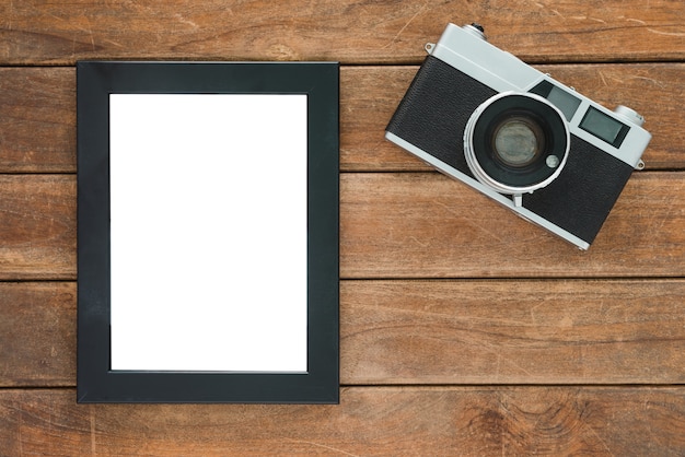 Office desk wooden table with old camera and poster mockup template