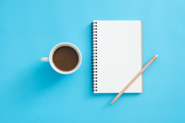 Office desk working space - Flat lay top view mockup of a working space with white blank notebook page