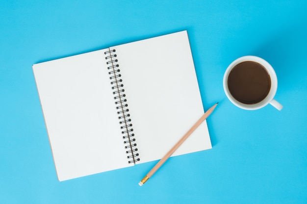 Office desk working space - Flat lay top view mockup of a working space with white blank notebook page