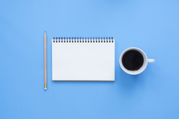 Office desk working space - Flat lay top view mockup of a working space with white blank notebook page