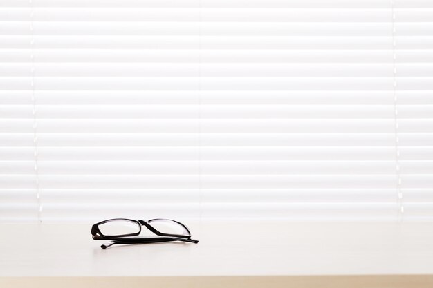 Office desk workplace with glasses on table