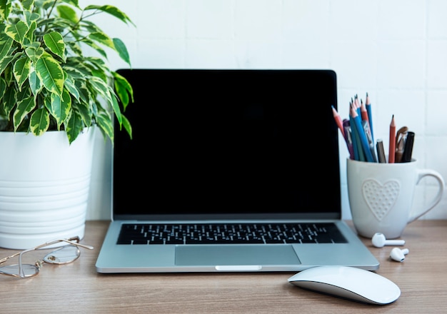 Office desktop. Laptop with office supplies on the table.