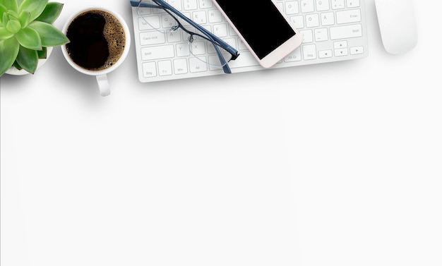 Office desktop with smartphone and coffee on white background with copyspace