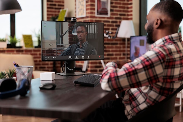 Office employees attending videocall meeting online on computer, talking on videoconference call with webcam. Chatting on remote teleconference with internet conversation, working remotely.