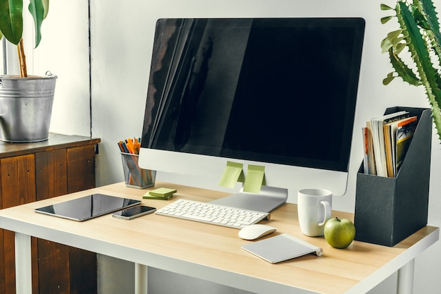 Office  or home workspace, Computer monitor with black screen on office table with supplies