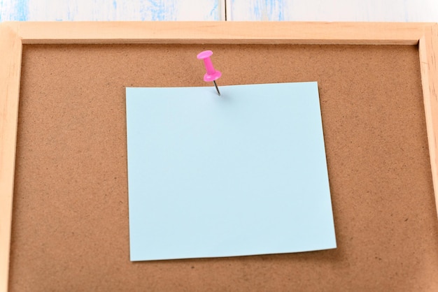 Office information board with attached blue sheet of paper with space for text