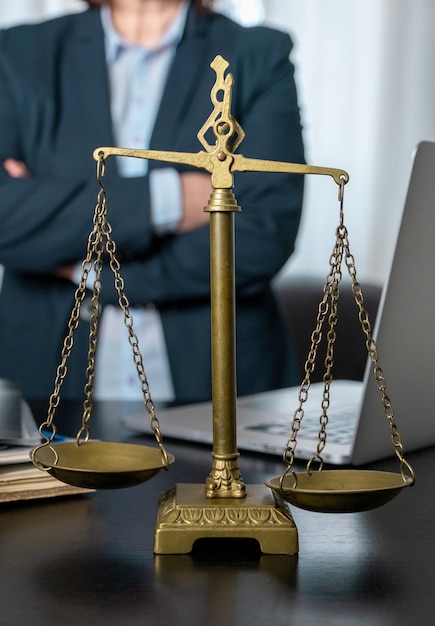 Office of Lawyer with Scales, laptop and documents on the workplace.