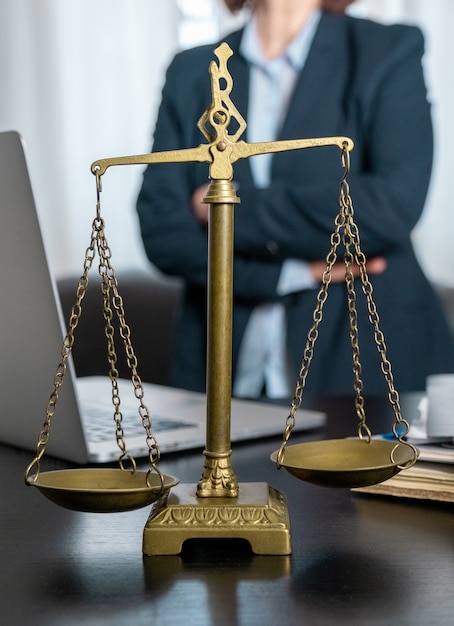 Office of Lawyer with Scales, laptop and documents on the workplace.