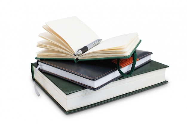 Office notepad and pen on top of the book, close-up. Organiser.