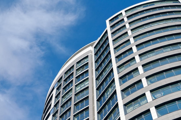 Office skyscraper high business building on blue sky background looking up to glass modern building