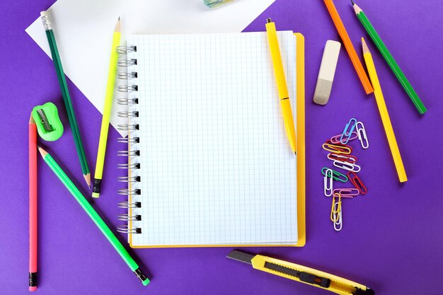 Office and student tools on purple background closeup