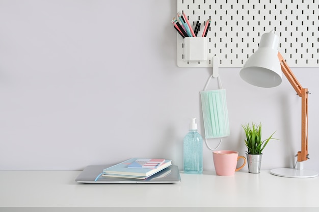 Office supplies and COVID 19 prevention items on a desk