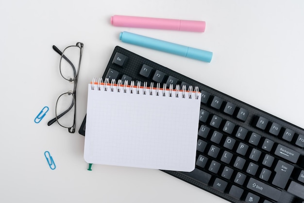 Office Supplies Over Desk With Keyboard And Glasses And Coffee Cup For Working Remotely Assorted School Utilities For Studying With Hot Drink And Eyeglasses