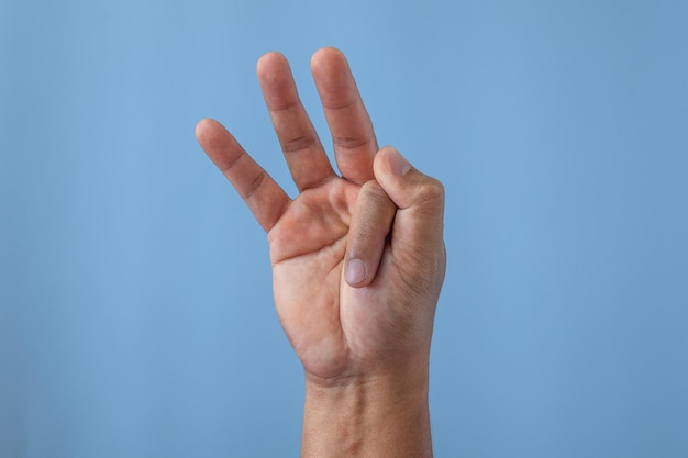 Office syndrome concept Index finger is stretched after working Close up shot isolates on blue background