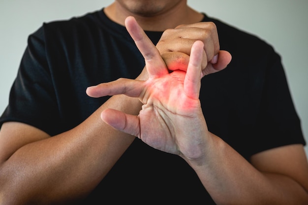 Office syndrome concept Ring finger is massaged and stretched after working Close up shot isolate on blue background Forehand view