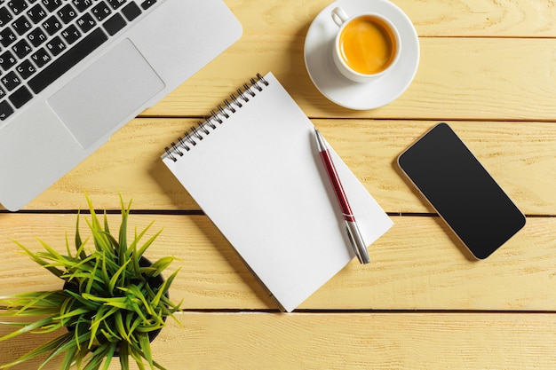 Office table background with coffee cup, pencils and computer keyboard