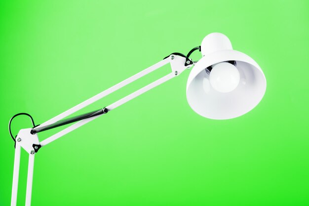 Office table lamp on green background with space for text and idea concept