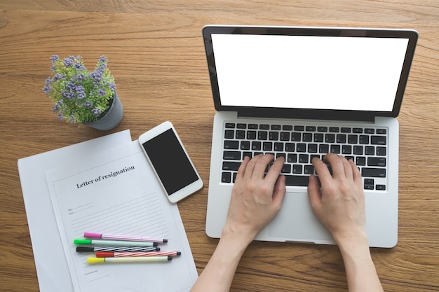 Office table with Human hand typing on notebook 