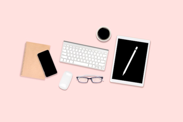 Office table with laptop computer, digital tablet, mobile phone and accessories.