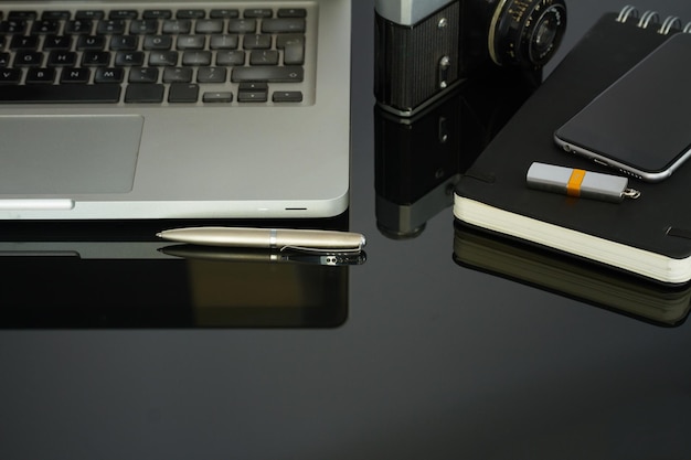 Office table with laptop phone and supplies