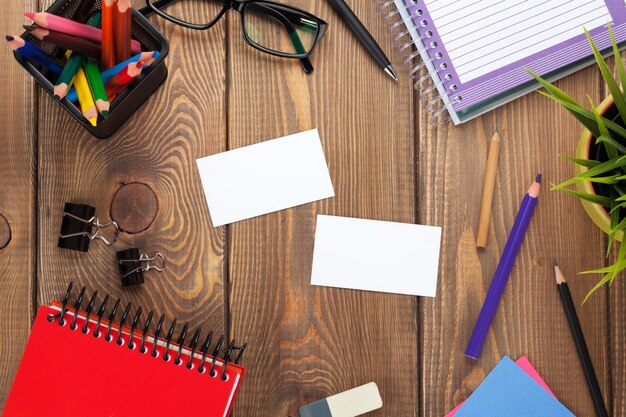 Office table with notepad colorful pencils supplies and business cards