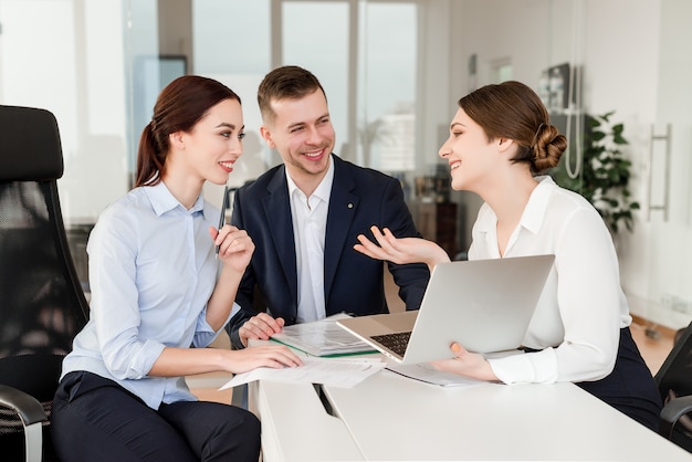 office workers doing a project together and laughing at their break in a modern company building