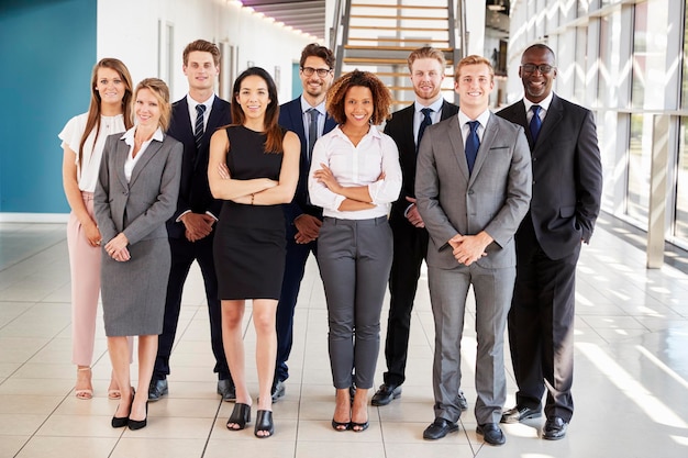 Office workers in a modern lobby full length group portrait