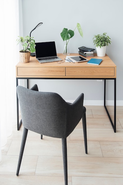 Office workplace with laptop on wooden table