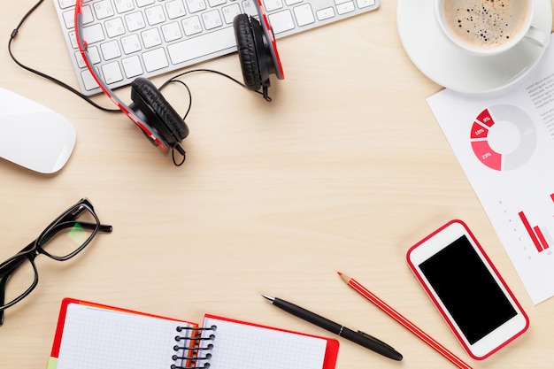 Office workplace with phone charts and coffee