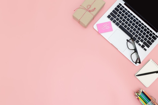 office workspace with blank laptop and clipboard in flat lay