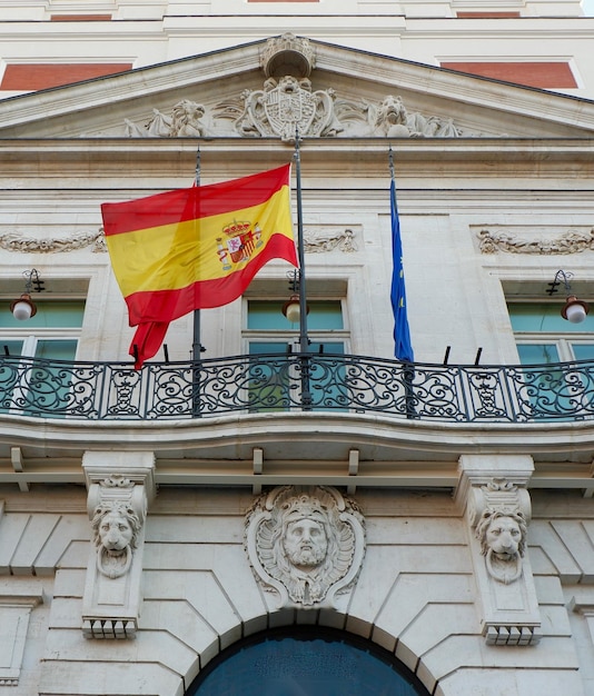 Photo official flag of spain on the governmental building in madrid spanish capital vertical photo