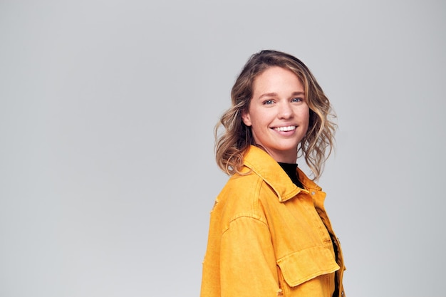 Offset Studio Portrait Of Positive Happy Young Woman Smiling Off Camera