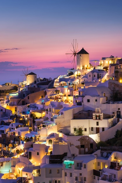 Oia village Santorini Greece View of traditional houses in Santorini Small narrow streets and rooftops of houses churches and hotels Landscape during sunset Travel and vacation photography