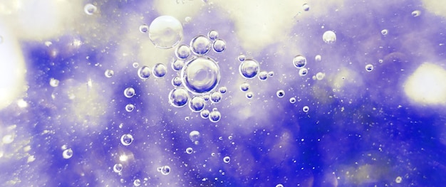 Oil bubbles close up. a circles of water macro. abstract light blue background. banner