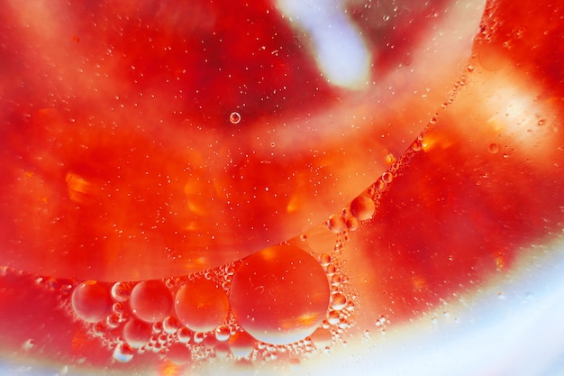 Oil bubbles close up. a circles of water macro. abstract orange and fiery red background