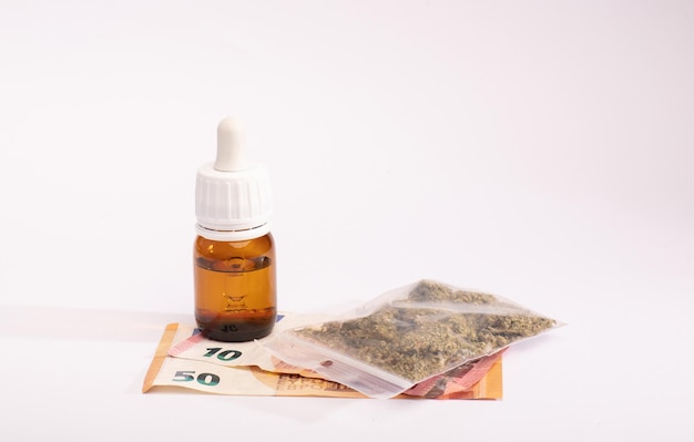 oil cannabis bottle and bag plastic money The concept of selling marijuana hemp and drugs