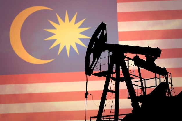 Oil pump on background of flag of Malaysia