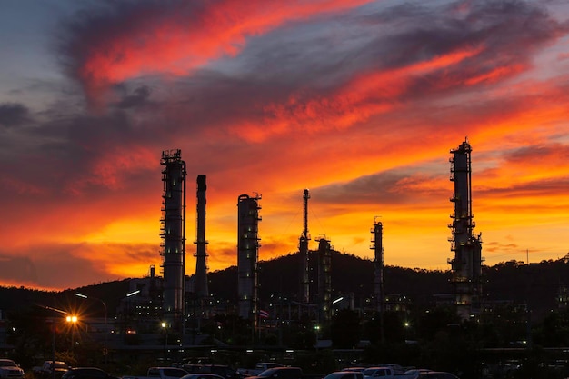 Oil refinery and plant and tower column of Petrochemistry industry in oil and gas industrial with cloud red sky the evening sunset