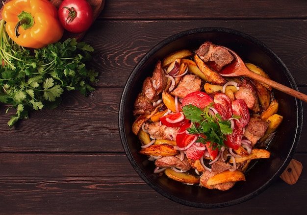 Ojakhuri Traditional Georgian dish fried potatoes with meat in a clay frying pan top view no people homemade