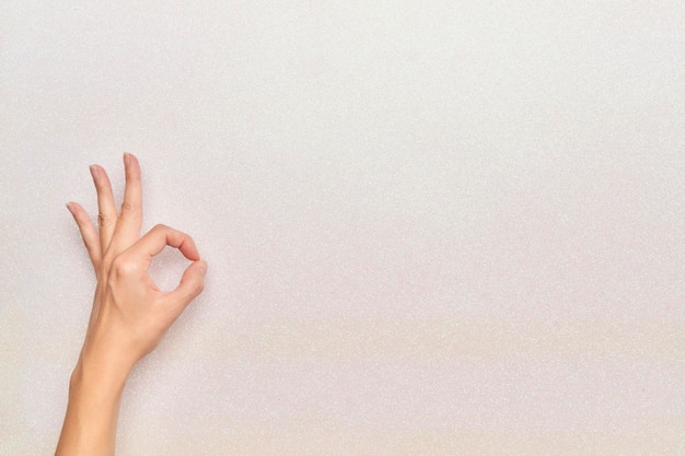 okay gesture on man hand with white glitter background