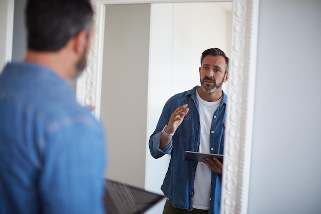 Okay you gotta do better than this Cropped shot of an attractive mature man having a rehearsal in the mirror while holding a digital tablet