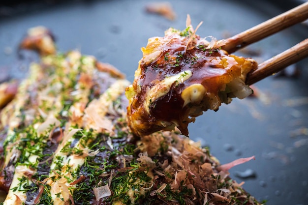 Okonomiyaki with a bite of chopsticks