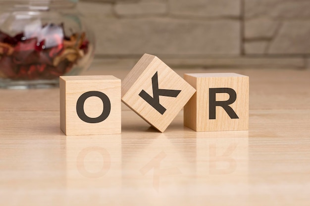 OKR acronym from wooden blocks with letters top view on grey background