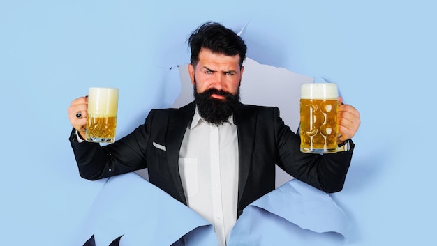 Oktoberfest serious bearded man with mugs of beer looking through paper lager and dark ale