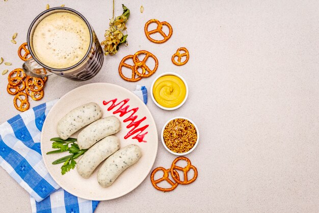 Oktoberfest set. Dark beer, weisswurst, pretzels, mustard, spikelets of grain, hop