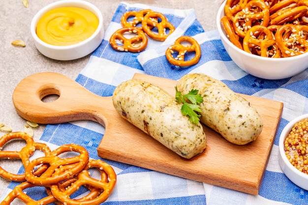 Oktoberfest set. White sausage weisswurst, pretzels, mustard, spikelets of grain, hop