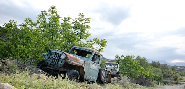 Old abandoned pickup truck in the meadow