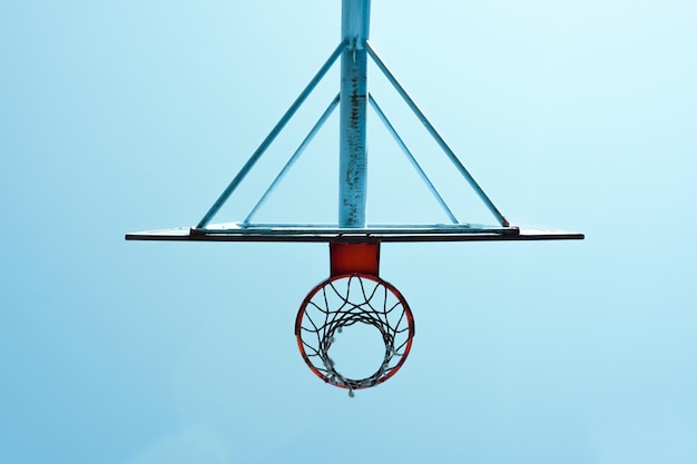 old abandoned street basketball hoop and blue sky background