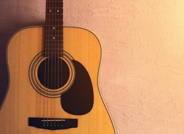 Old acoustic guitar on a sandy texture. sunlight.